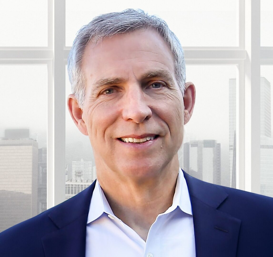 Smiling middle-aged man in suit by window