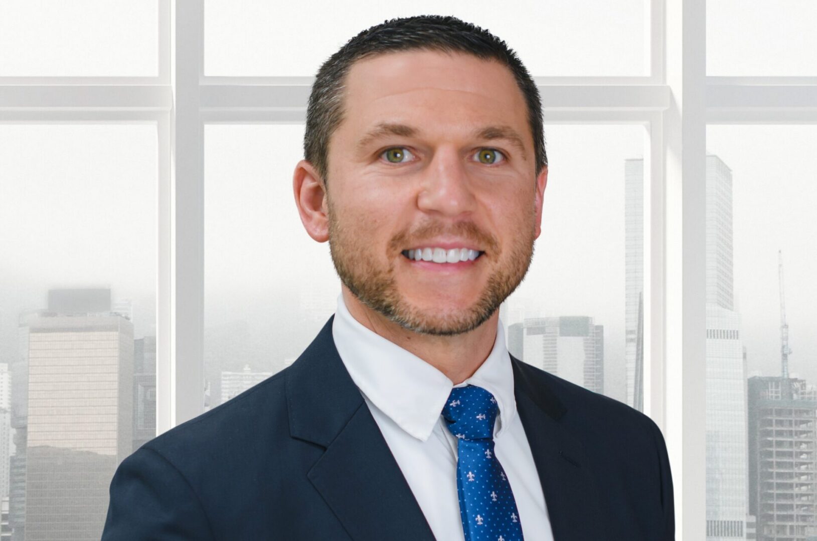 Smiling businessman in suit with city skyline