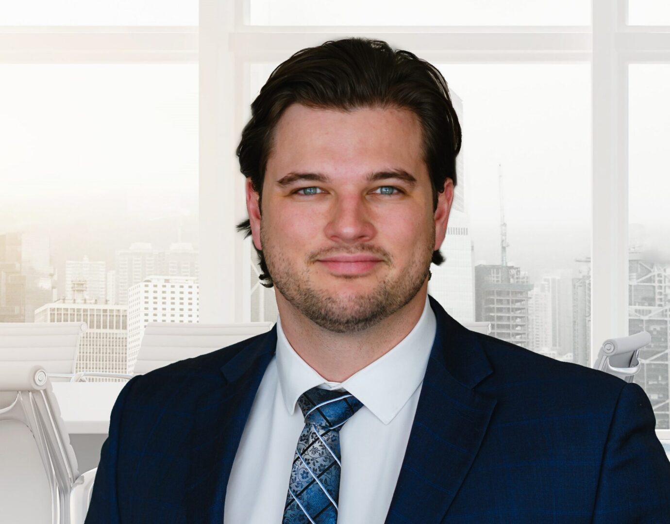 Business professional in navy suit by office window
