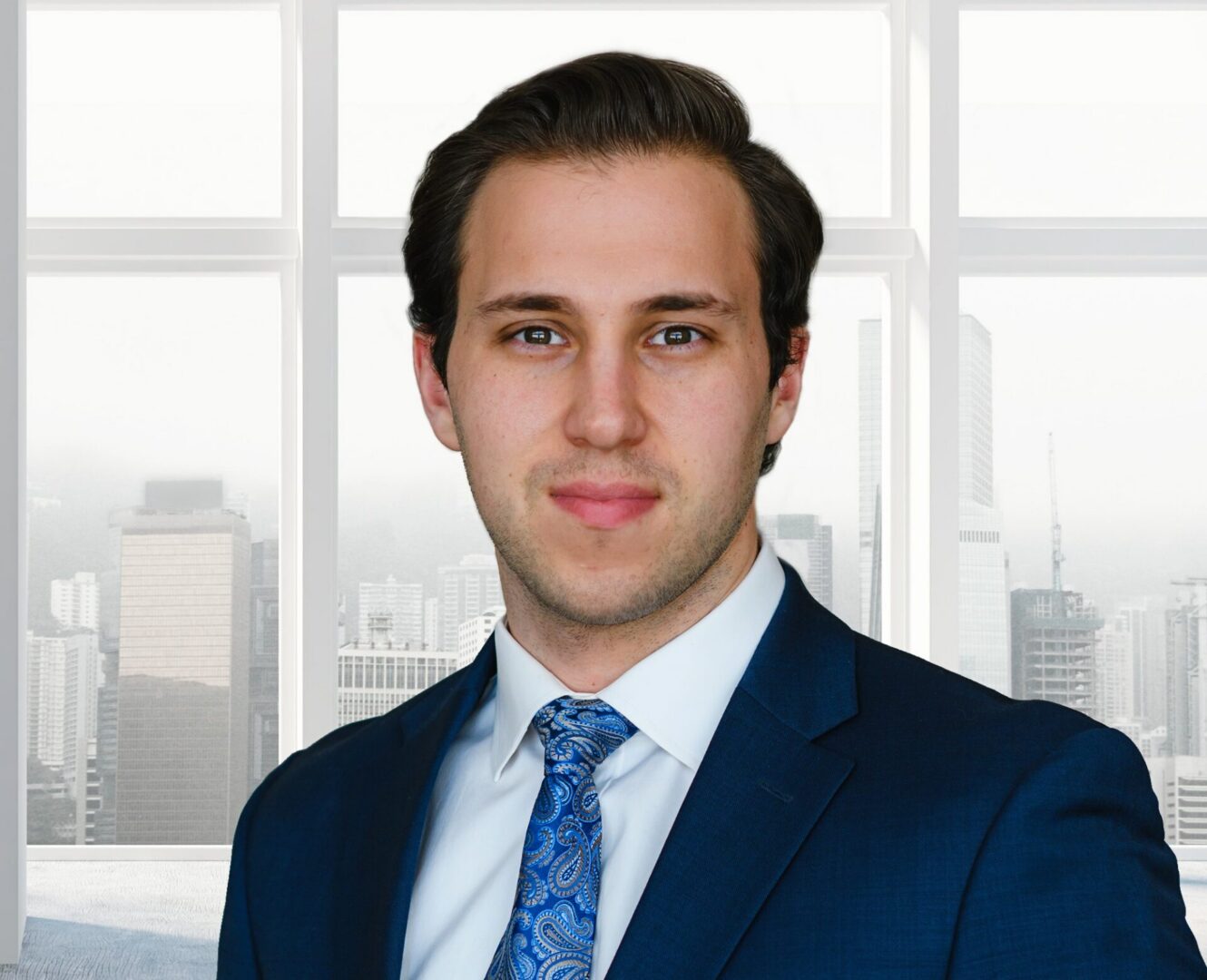 Professional businessman in suit by city window