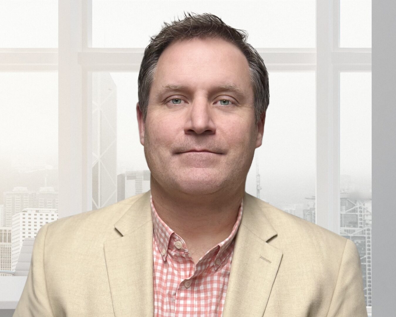 Middle-aged man in beige blazer by window