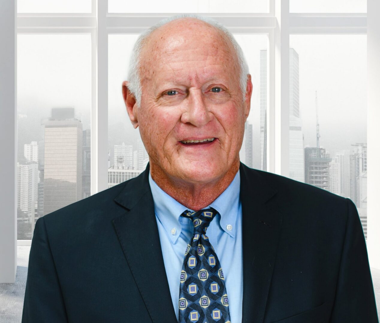 Smiling senior businessman in suit by office window